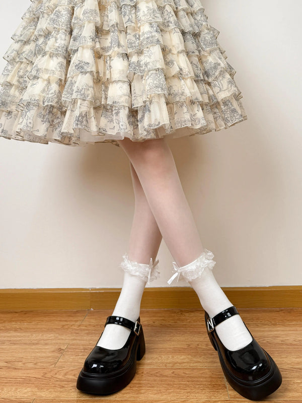 White and black layered ruffle socks with lace edging and bows