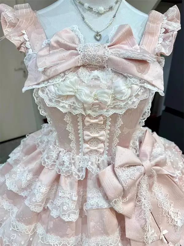 Pink layered-lace JSK dress with bows on a mannequin