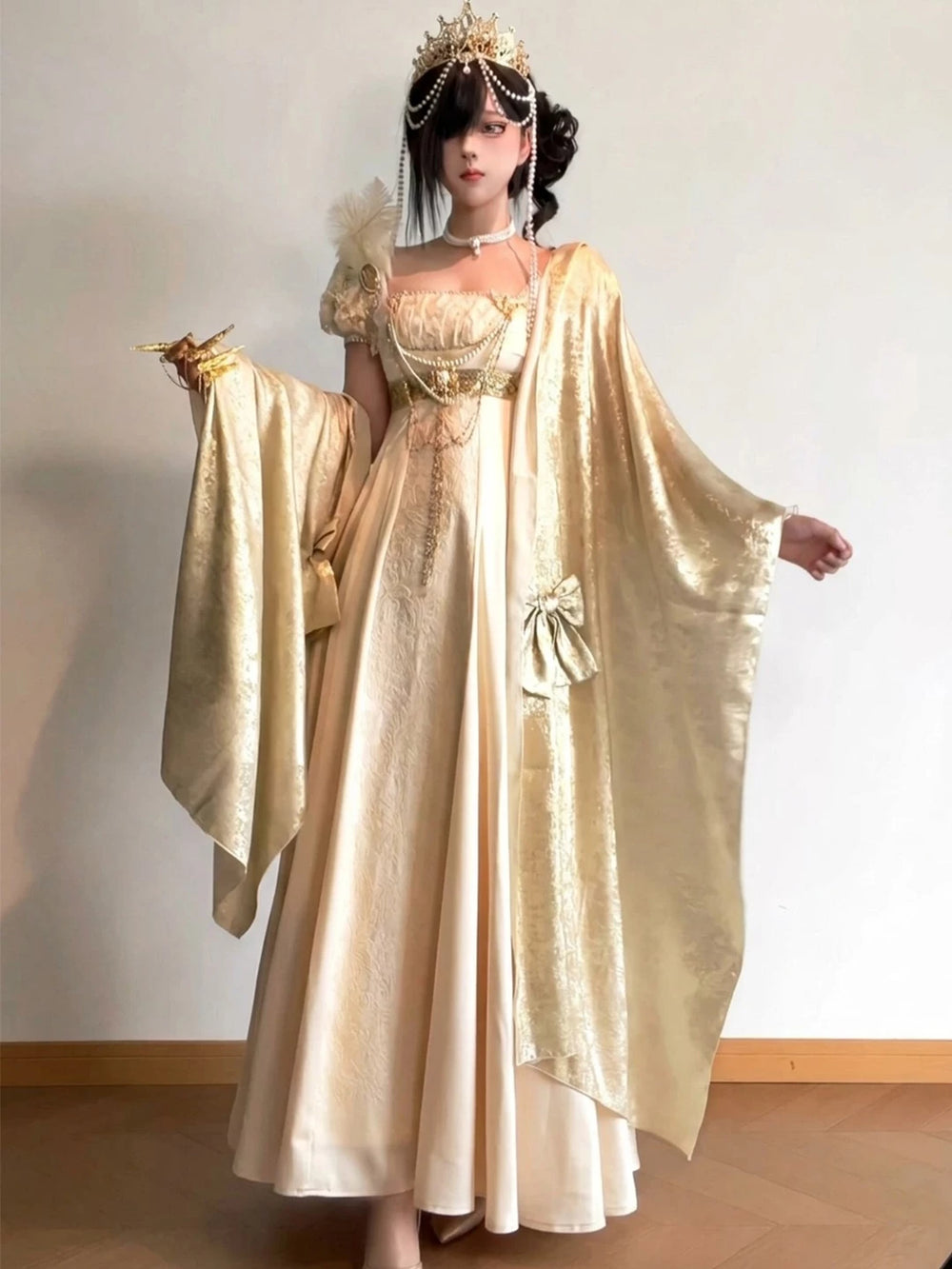 Ivory-gold Lolita dress with matching shoulder drape and puff sleeves shown on a model.