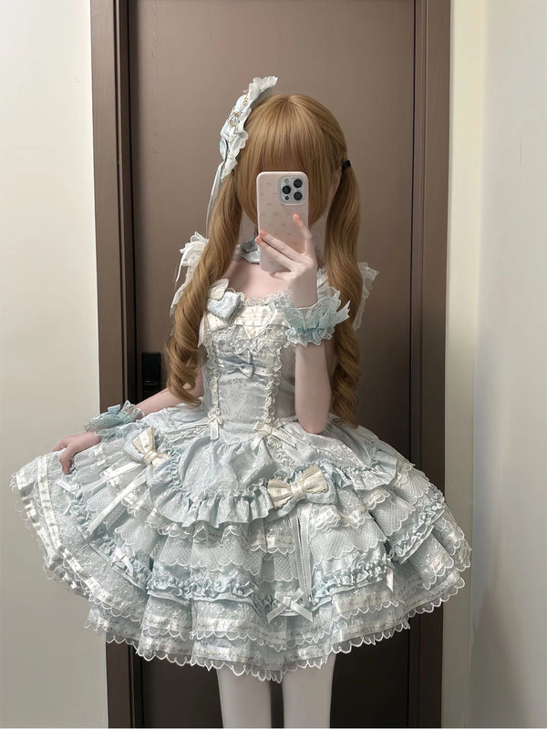 Pale blue tiered JSK dress with white lace, bows, and a full skirt.
