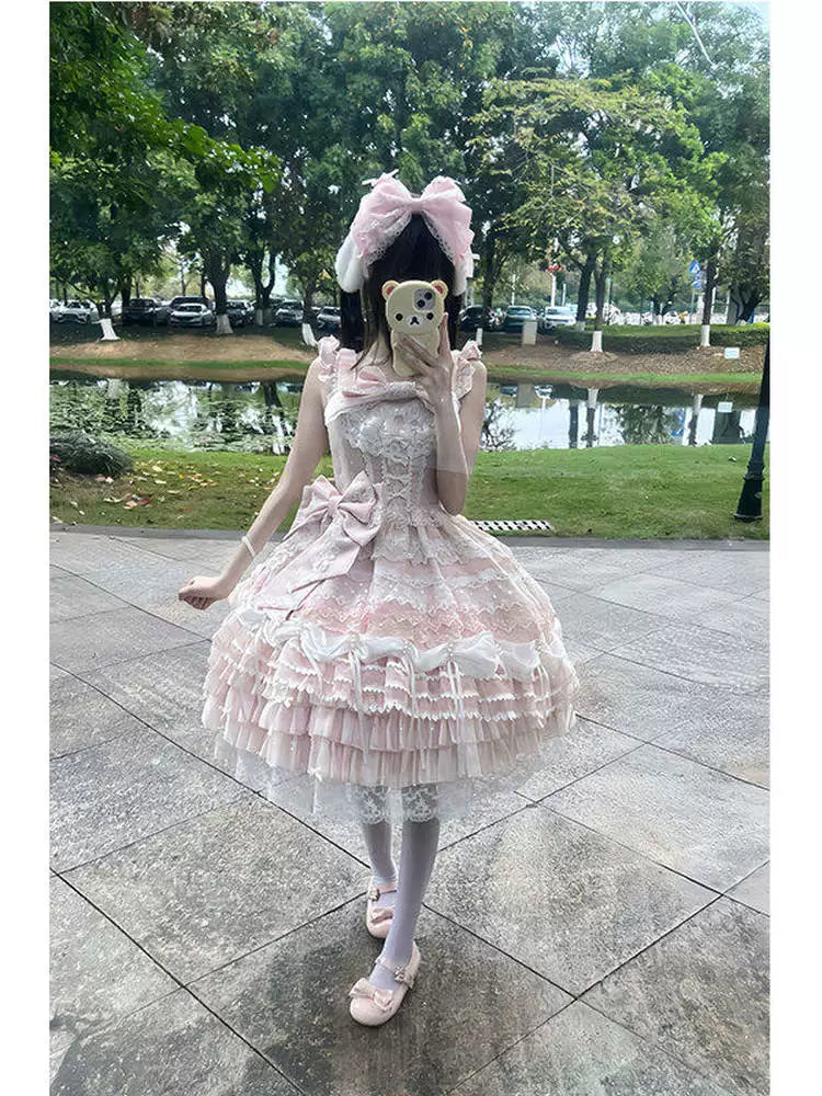 Pink lace JSK with layered ruffles, waist bow, and matching hair accessory