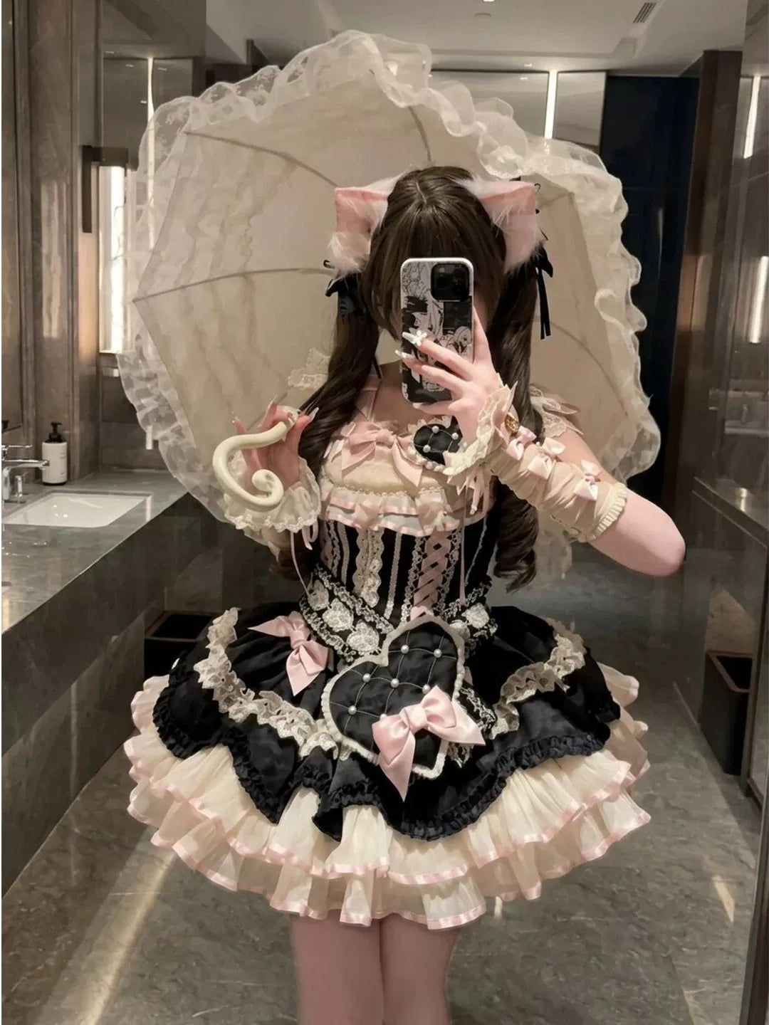Black JSK dress with cream ruffles, pink bows and a large heart detail.
