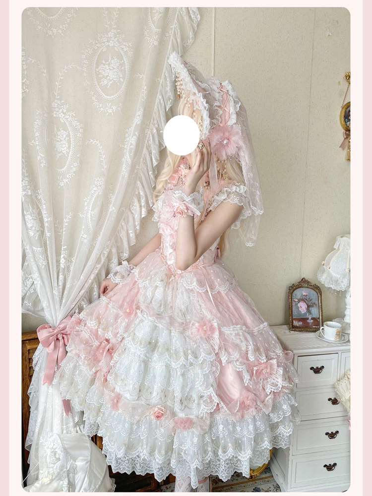 Back view of gown featuring large waist bow and sheer overlay with floral motifs