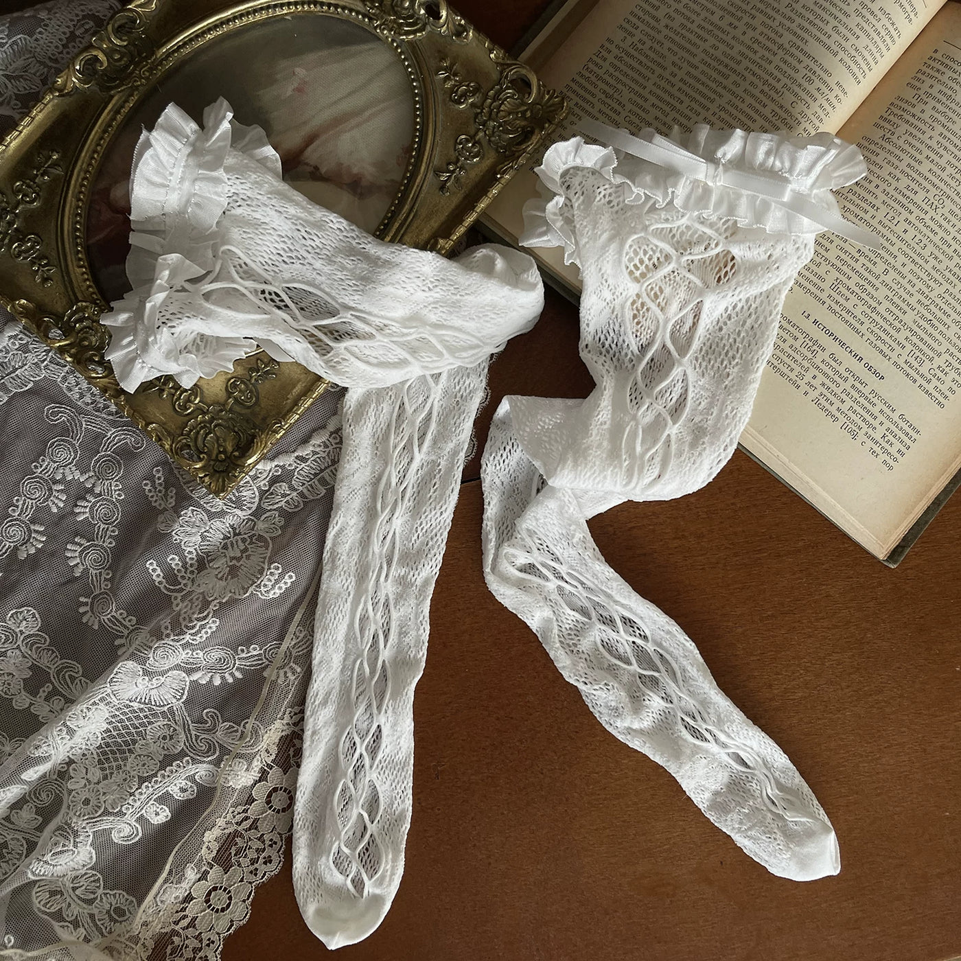 White lace stockings, strap sock covers and flared sock covers styled with a chain