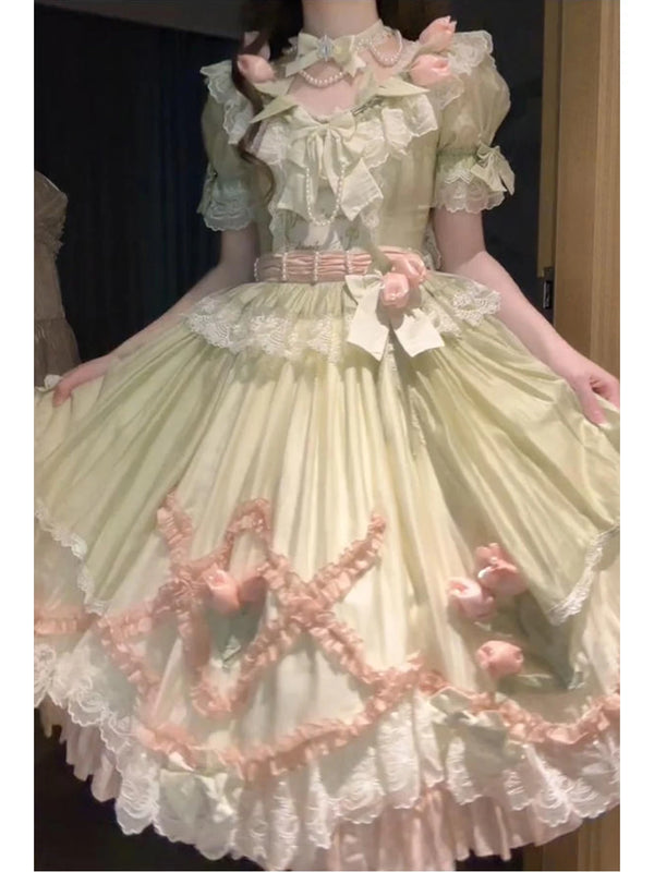 Green-and-pink Classic Lolita dress with layered lace, bows and floral accents shown from the front