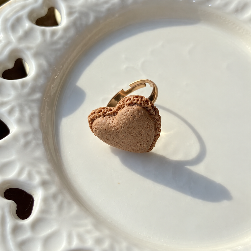 Bear doll chocolate heart pastry adjustable ring, close-up showing the charm and gold-tone band.