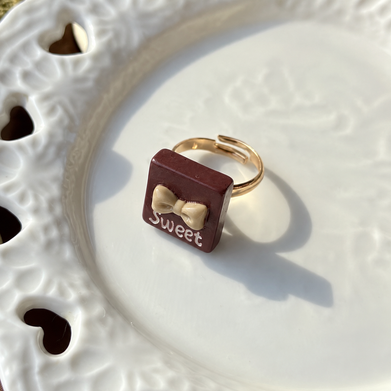 Bear doll dark chocolate square adjustable ring, close-up showing the charm and gold-tone band.