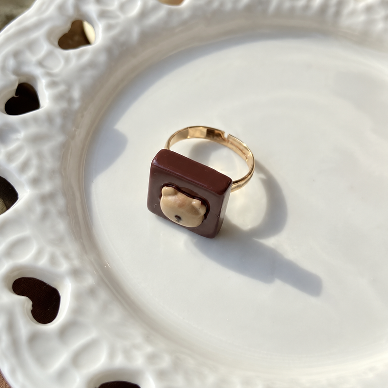 Bear doll teddy bear chocolate adjustable ring, close-up showing the charm and gold-tone band.