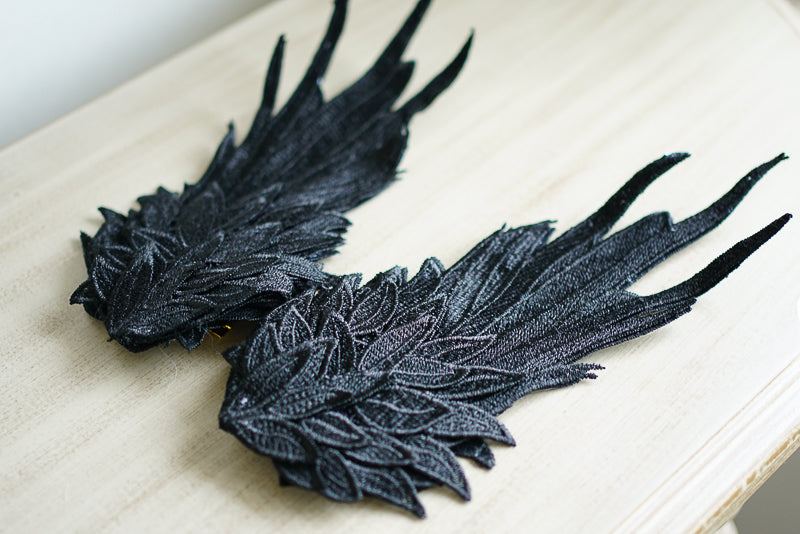 Black and white two-tone angel wings feather headdress with embroidered LolitaFetch styling hair clip, featuring a delicate, decorative design.