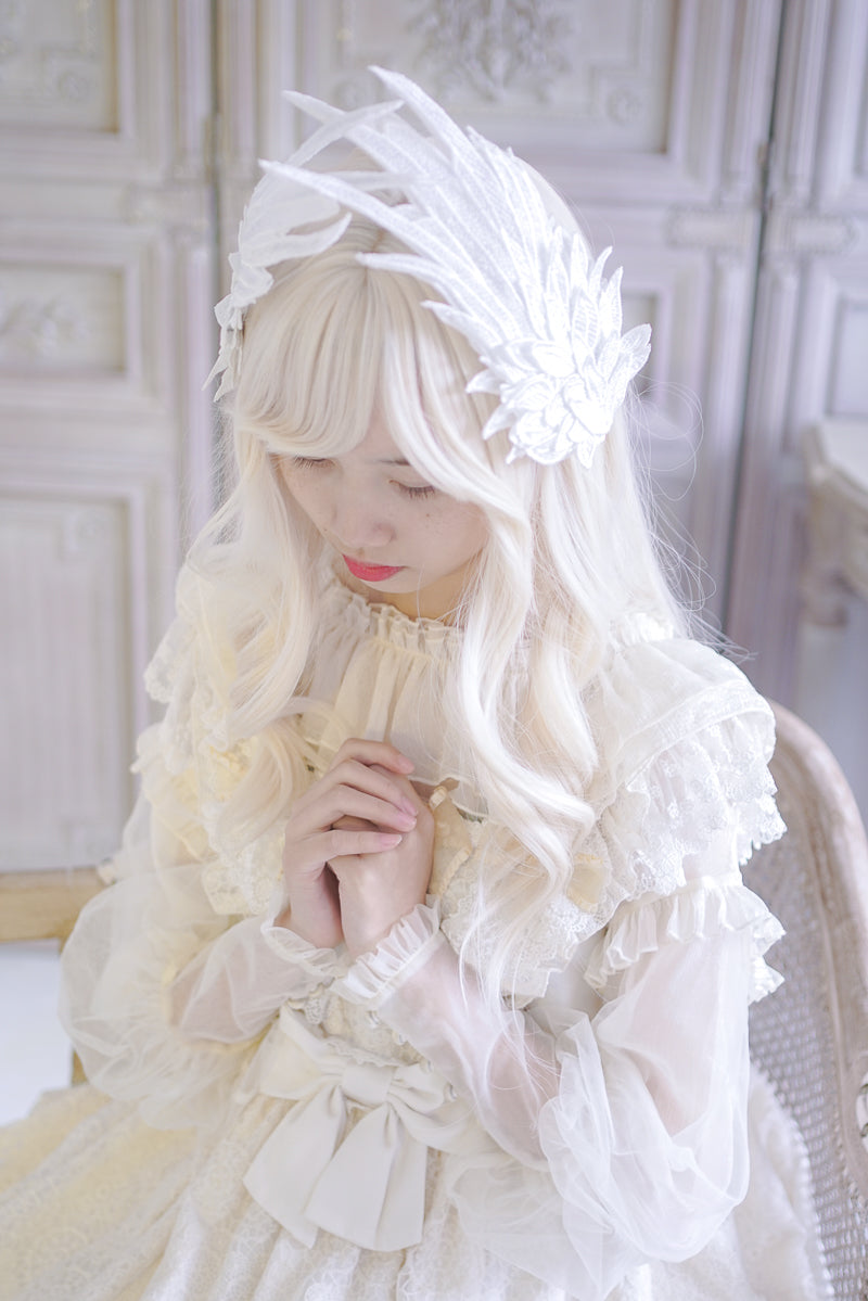 Black and white embroidered angel wings LolitaFetch hair clip with feather detailing and two-tone design, styled as a headdress accessory.