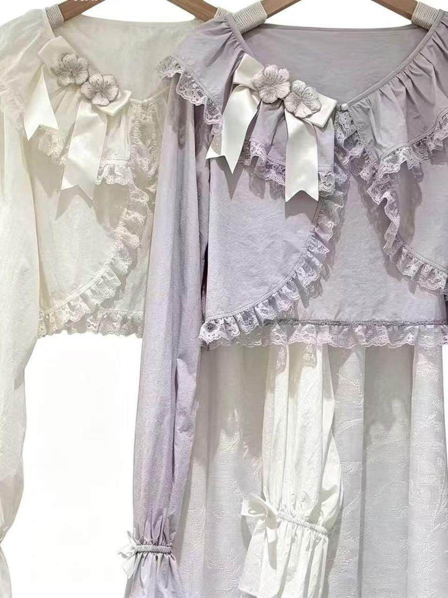 Beige apricot Sweet Lolita cropped lace cardigan with bow accents, long sleeves, and ruffled collar