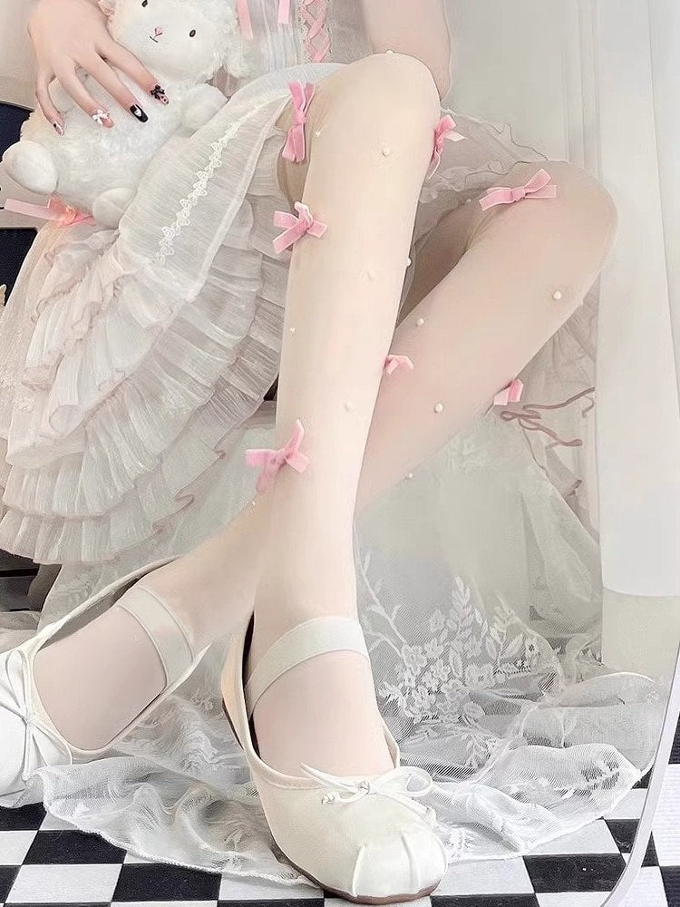 Black sheer Lolita tights with black bow accents and pearl embellishments