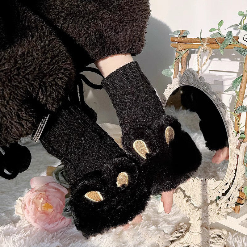 Close-up of plush glove texture and metallic animal-eye accents