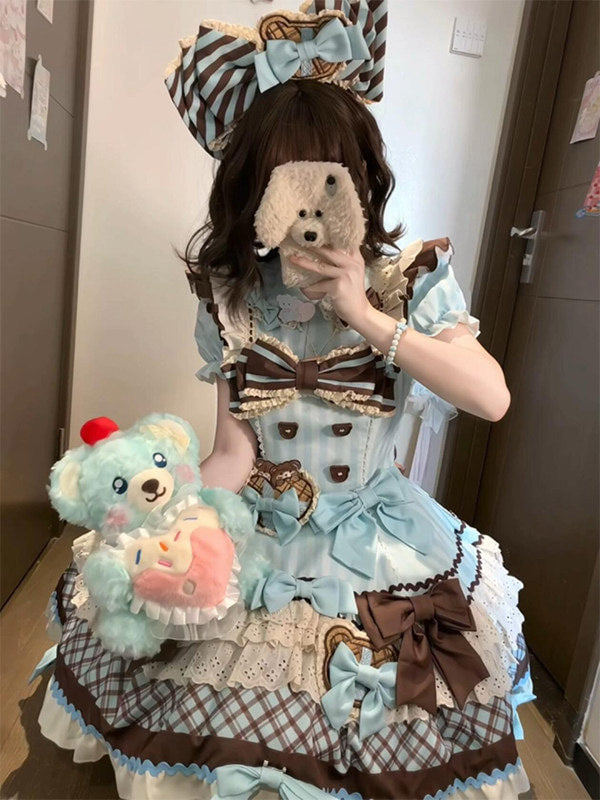 Close-up of the dress bodice with cookie appliqués and central brown bow