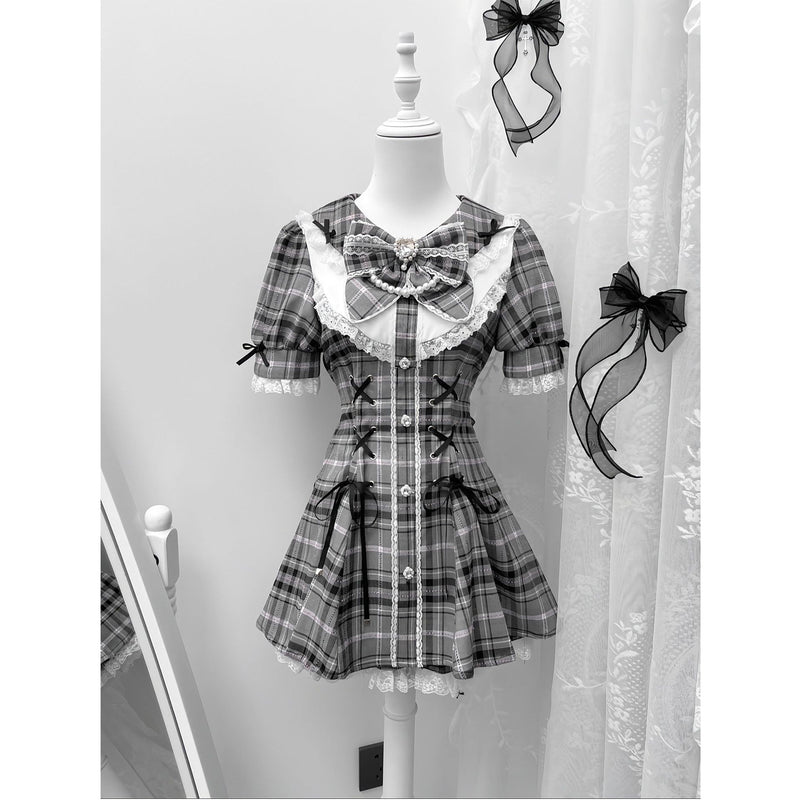 Grey plaid dress with lace trim, ribbons and a large neckline bow.