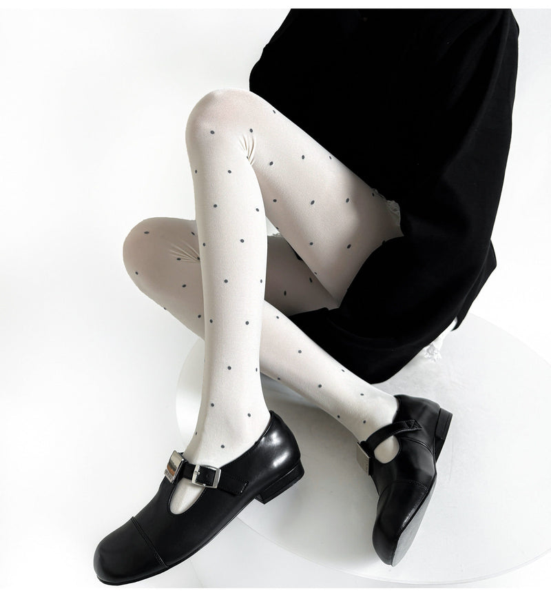 Grey patterned tights with scattered small dots.