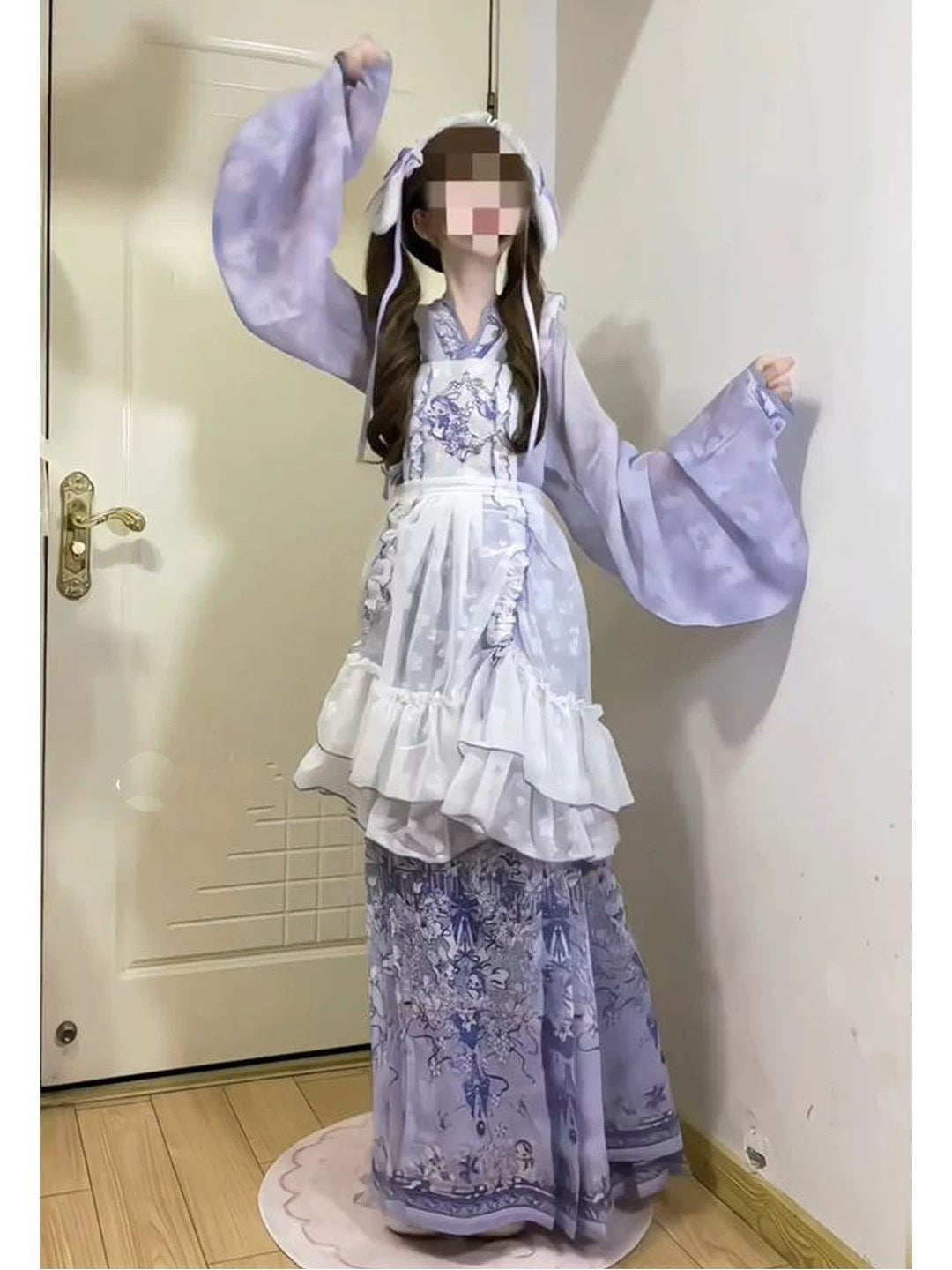 Full view of periwinkle pleated skirt with dark navy floral print and included white hairband