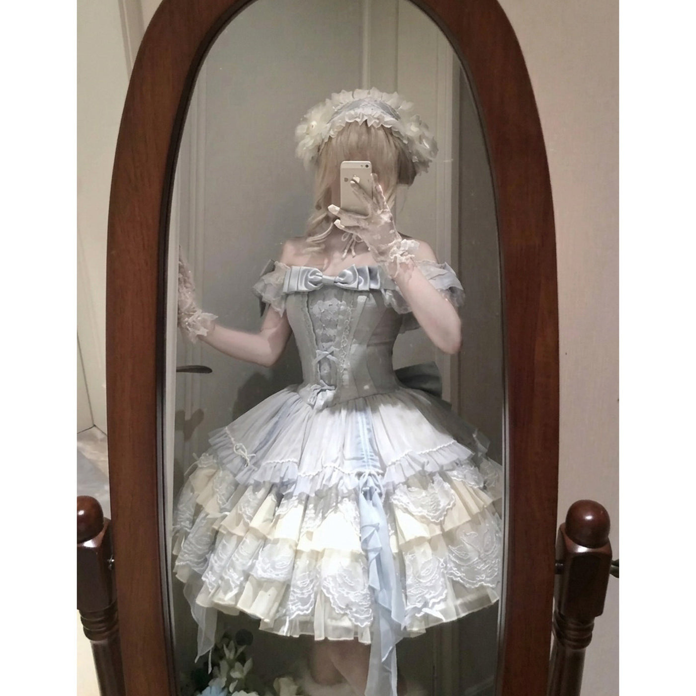 Detail shot of tiered blue lolita skirt with appliqué lace and ribbon streamers