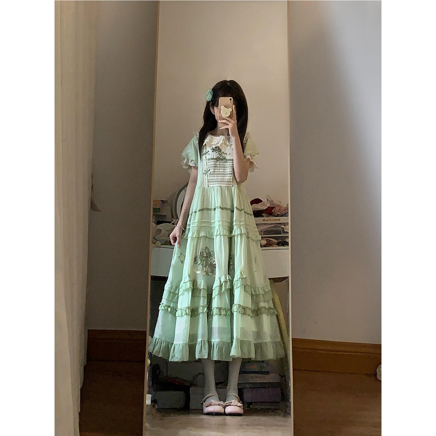 Side view of the green Sweet Lolita OP dress showing tiered ruffled skirt and waist gathering