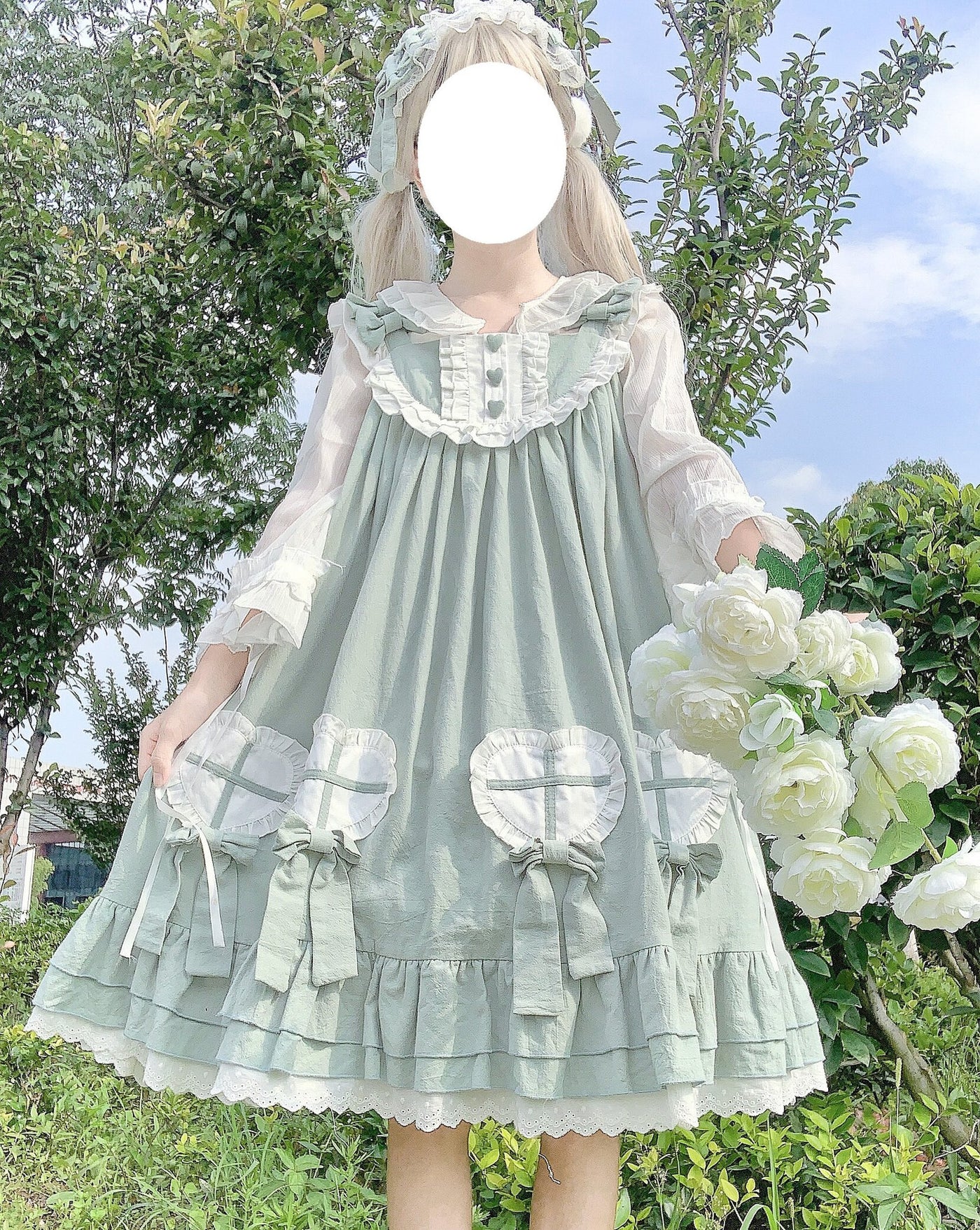 Light green JSK dress with ruffles, heart-shaped panels, and bow details.
