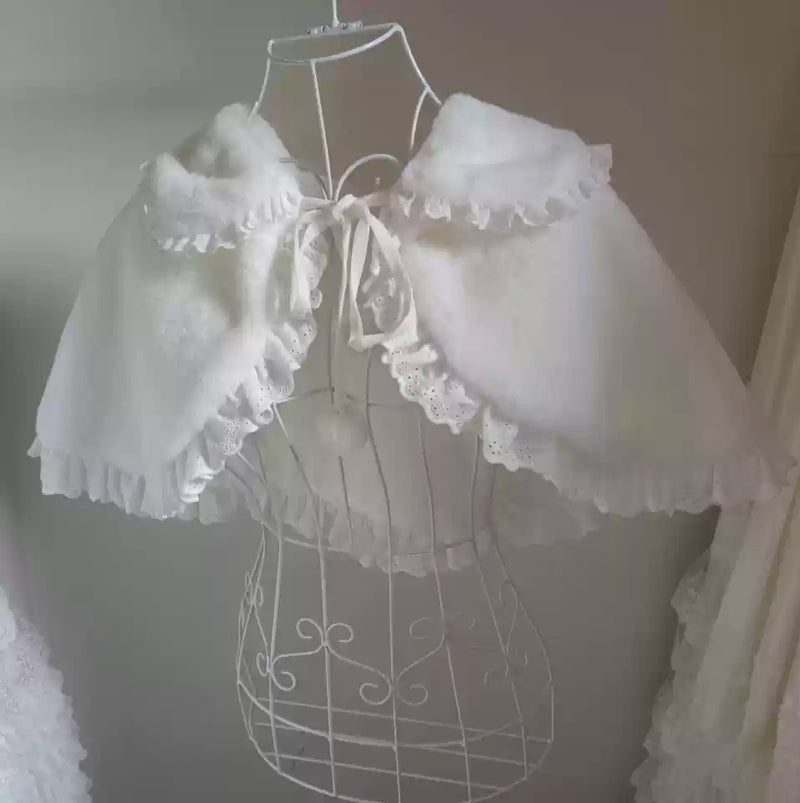 White rabbit-style plush Snowflake Bear cape with a fluffy collar, lace trim and ribbon ties, full front view.