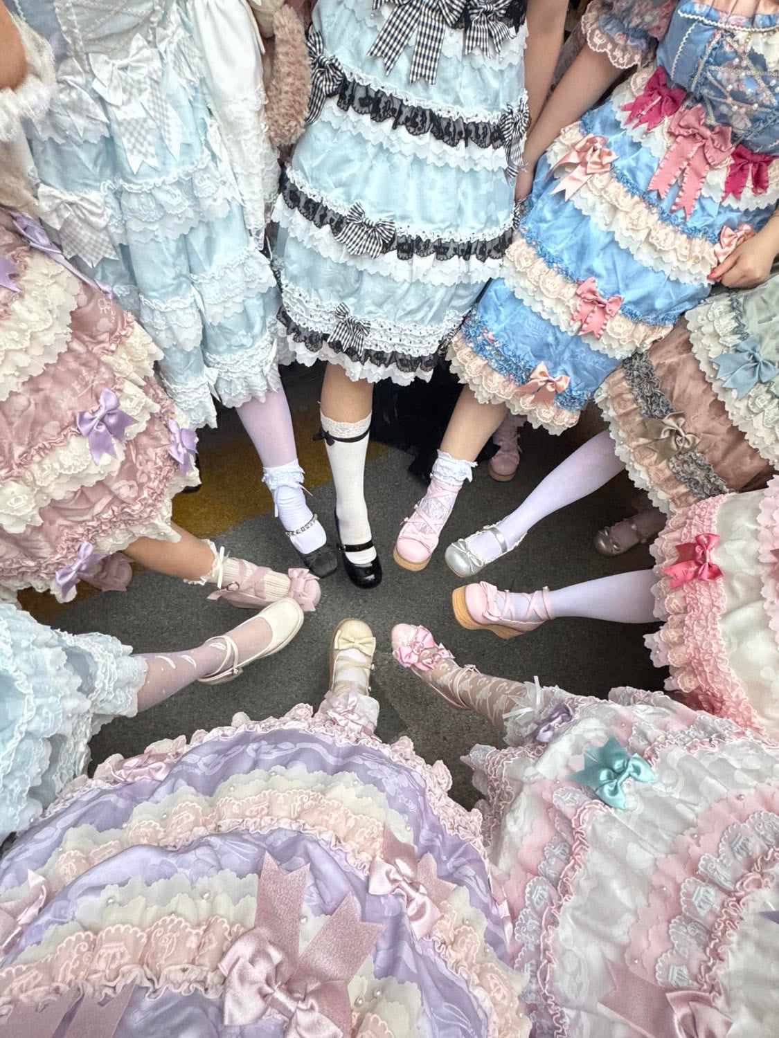 A circle of Lolita coordinates showing dresses, socks and shoes together.