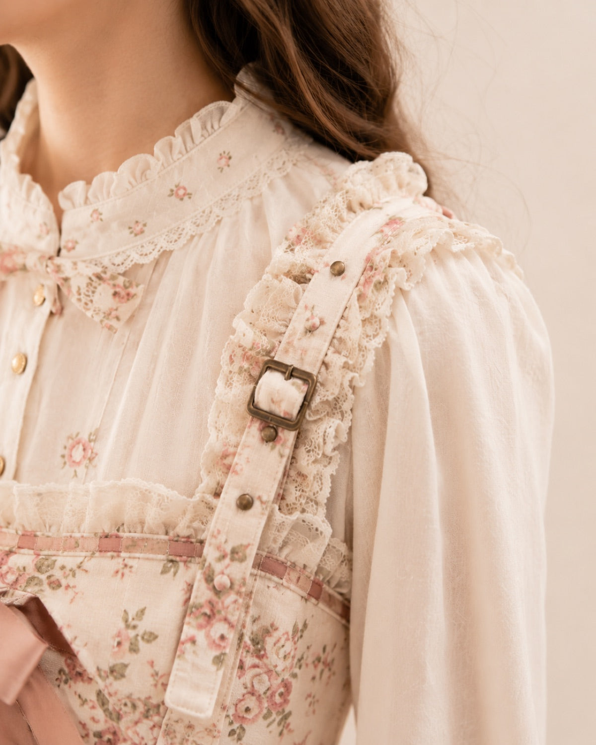 Adjustable shoulder straps on a floral Lolita jumper skirt.